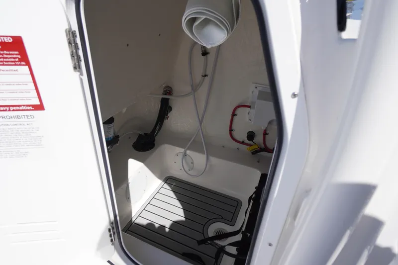 Slide: The Image of Interior view of 2025 Tidewater 210 LXF boat compartment with equipment and storage space. - 18