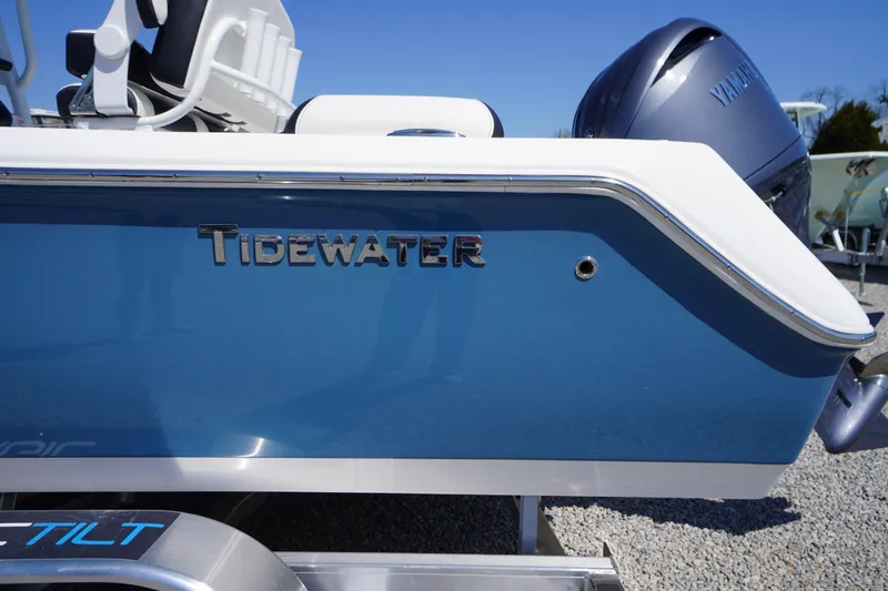 Slide: The Image of 2025 Tidewater 210 LXF boat side view with Yamaha engine, blue and white design. - 2