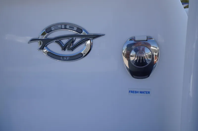 Slide: The Image of 2025 Tidewater 210 LXF boat emblem and fresh water access point. - 21