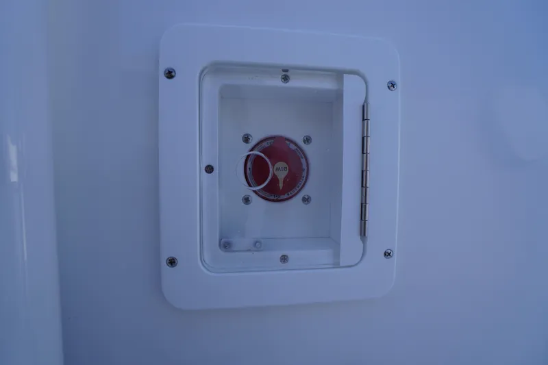 Slide: The Image of Battery switch on 2025 Tidewater 210 LXF boat, enclosed in a white compartment. - 22