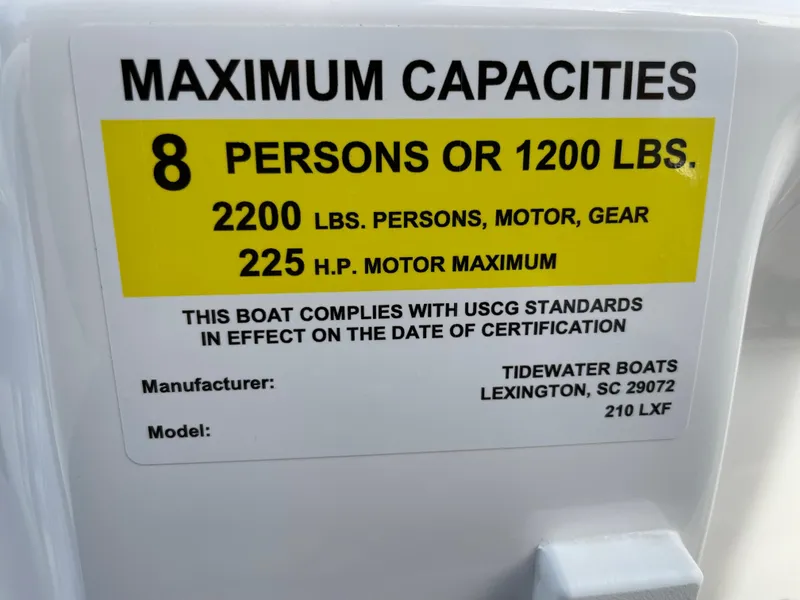 Slide: The Image of 2024 Tidewater 210 LXF boat capacity label, 8 persons or 1200 lbs, 225 HP motor max. - 23