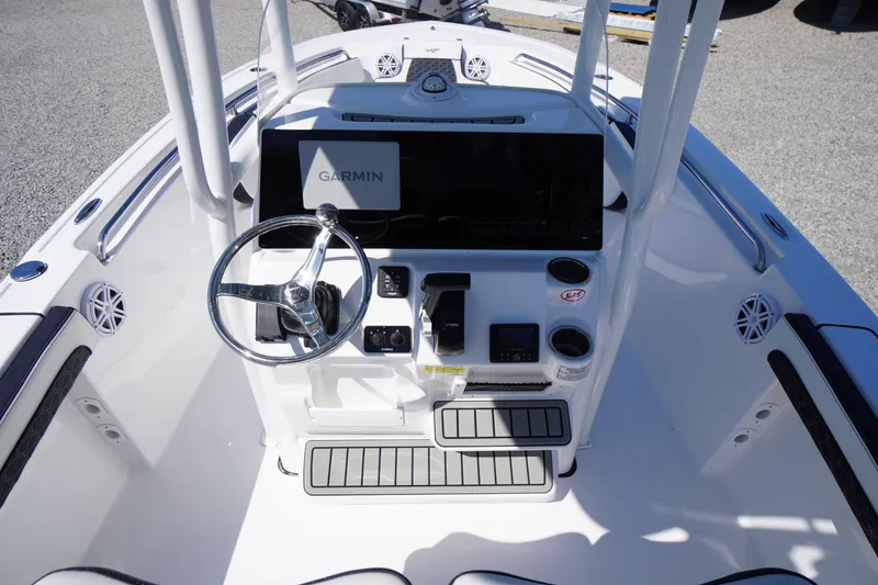 Slide: The Image of 2025 Tidewater 210 LXF boat console with Garmin navigation system and steering wheel. - 24