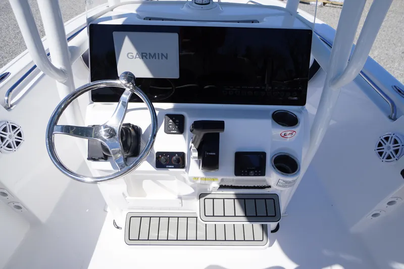 Slide: The Image of 2025 Tidewater 210 LXF boat console with Garmin display and steering wheel. - 25