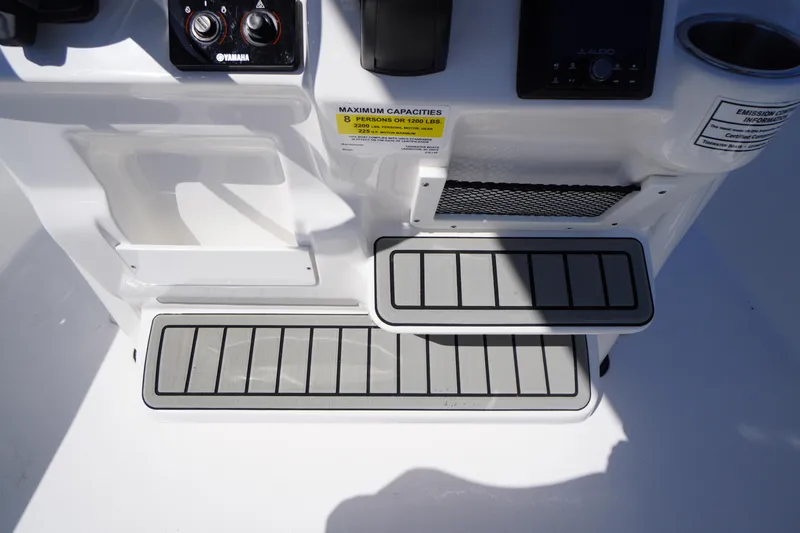 Slide: The Image of 2025 Tidewater 210 LXF boat console with controls and capacity label. - 27