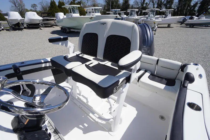 Slide: The Image of 2025 Tidewater 210 LXF boat interior with dual seating and steering wheel. - 29