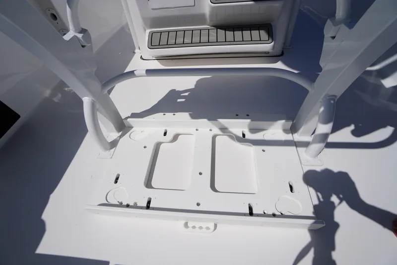 Slide: The Image of 2025 Tidewater 210 LXF boat interior, showcasing white deck and seating area. - 35