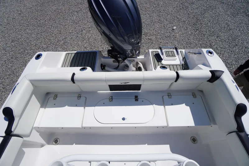 Slide: The Image of 2025 Tidewater 210 LXF boat interior with seating and motor, viewed from above. - 37