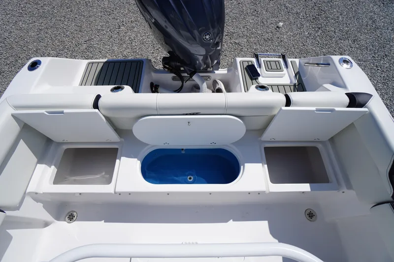 Slide: The Image of 2025 Tidewater 210 LXF boat interior with storage compartments and seating. - 38