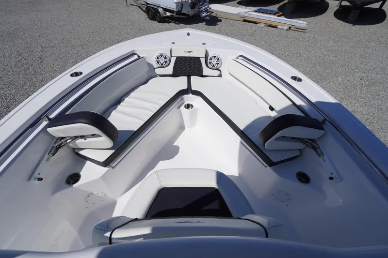 Slide: The Image of 2025 Tidewater 210 LXF boat interior with cushioned seating and speakers. - 4