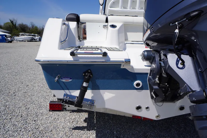 Slide: The Image of 2025 Tidewater 210 LXF boat rear view with outboard motor in a gravel lot. - 42