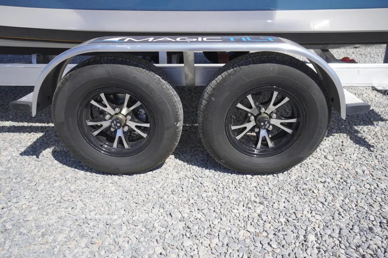 Slide: The Image of Trailer wheels of a 2025 Tidewater 210 LXF boat on gravel surface. - 44