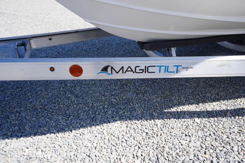 Slide: The Image of 2025 Tidewater 210 LXF boat on Magic Tilt trailer, parked on gravel. - 45