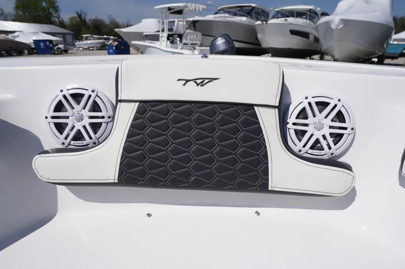 Slide: The Image of 2025 Tidewater 210 LXF boat interior with speakers and stylish upholstery. - 6