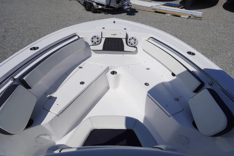 Slide: The Image of 2025 Tidewater 210 LXF boat interior with cushioned seating and speakers. - 7