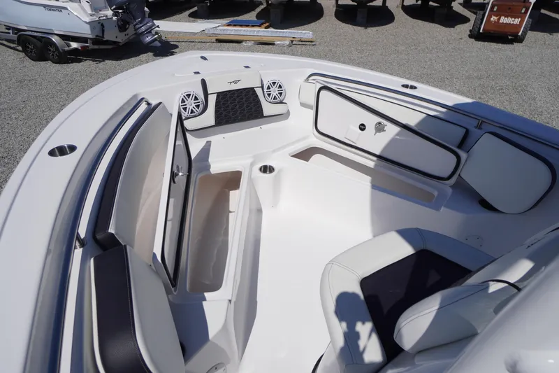 Slide: The Image of 2025 Tidewater 210 LXF boat interior with seating, storage, and speakers. - 9