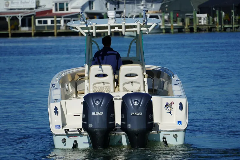Slide: The Image of 2018 Sailfish 290 CC boat with dual Yamaha 250 engines on water. - 1