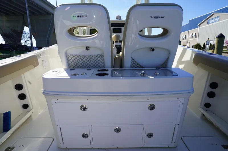 Slide: The Image of 2018 Sailfish 290 CC boat interior with dual seats and storage compartments. - 5
