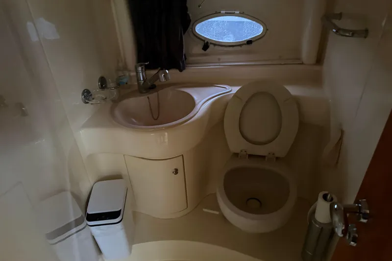 Slide: The Image of Bathroom interior of 2004 Azimut 39E yacht with sink, toilet, and porthole window. - 13