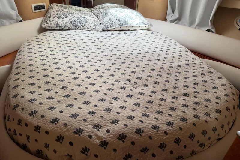 Slide: The Image of Cozy bedroom with patterned bedding in a 2004 Azimut 39E yacht cabin. - 14