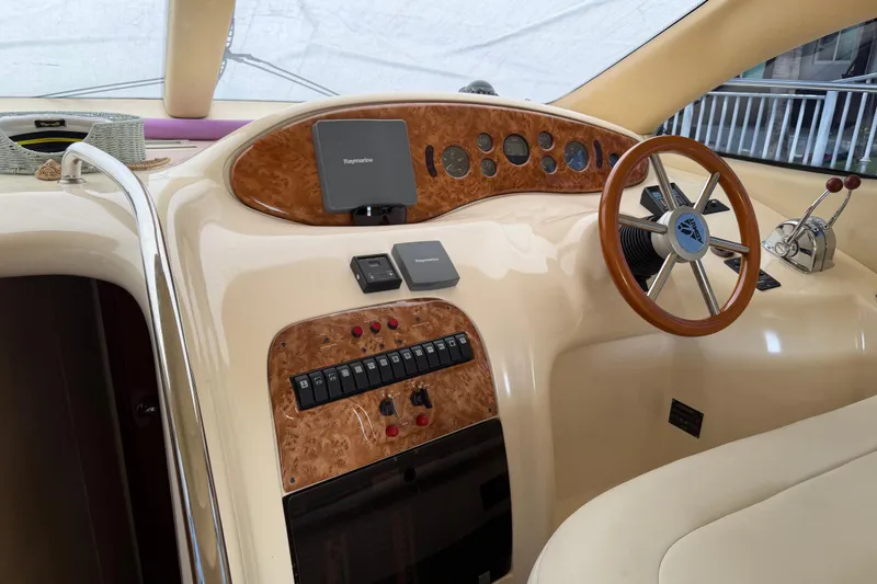 Slide: The Image of Interior helm of 2004 Azimut 39E yacht with wood accents and navigation controls. - 15