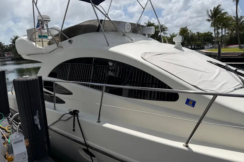 Slide: The Image of 2004 Azimut 39E yacht docked, featuring sleek design and modern amenities. - 3