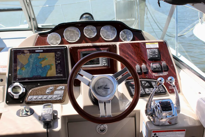 Slide: The Image of Cockpit of 2011 Sea Ray Sundancer 350 with navigation system and controls. - 13