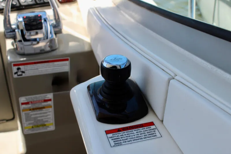 Slide: The Image of Control panel of a 2011 Sea Ray Sundancer 350 boat with joystick and throttle. - 14