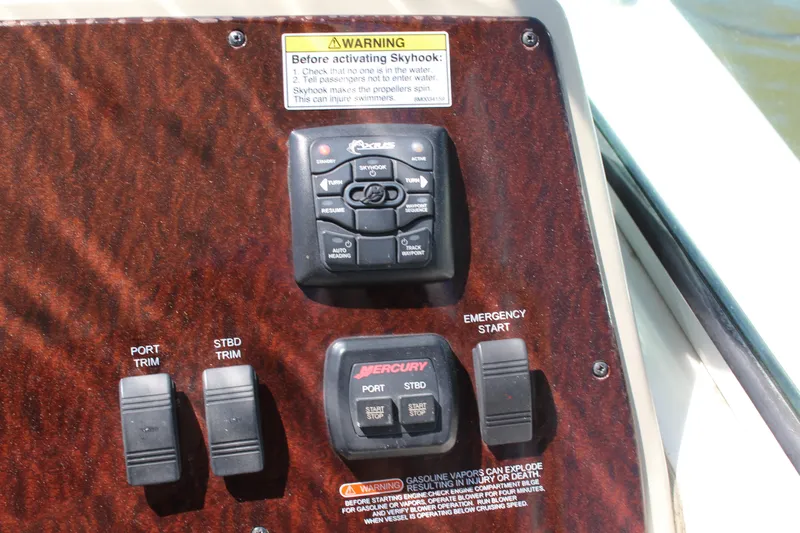 Slide: The Image of Control panel of a 2011 Sea Ray Sundancer 350 boat with warning labels. - 18