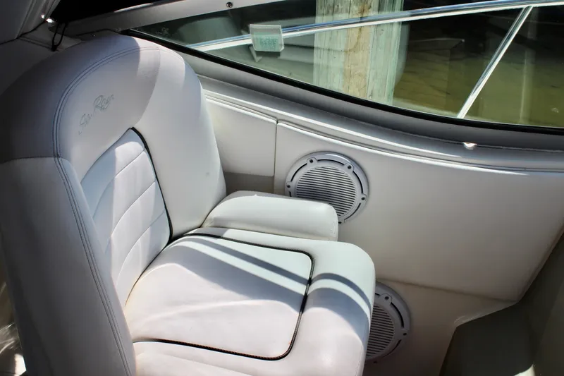 Slide: The Image of Interior seating of 2011 Sea Ray Sundancer 350 boat, featuring white upholstery and speaker. - 19