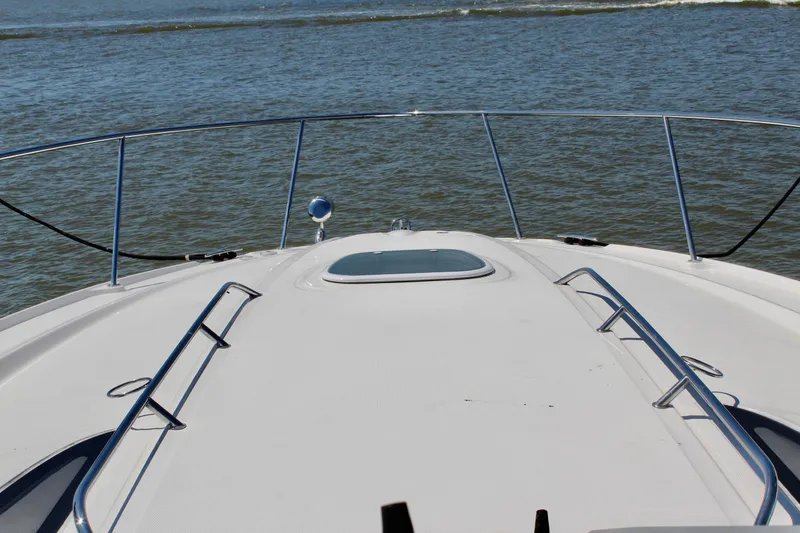 Slide: The Image of Bow view of 2011 Sea Ray Sundancer 350 yacht on open water. - 23
