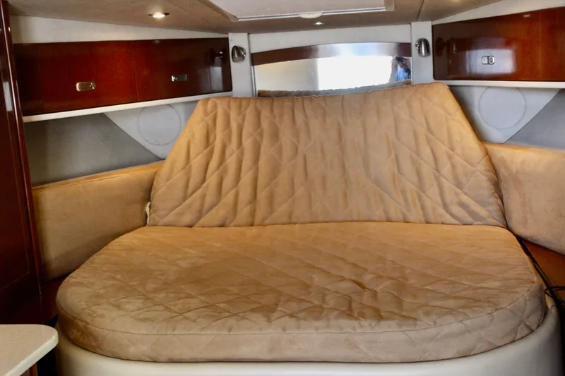 Slide: The Image of Interior cabin of 2011 Sea Ray Sundancer 350 with beige cushioned seating. - 24