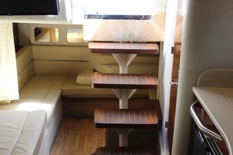 Slide: The Image of Interior of 2011 Sea Ray Sundancer 350 with wooden steps and beige seating area. - 27