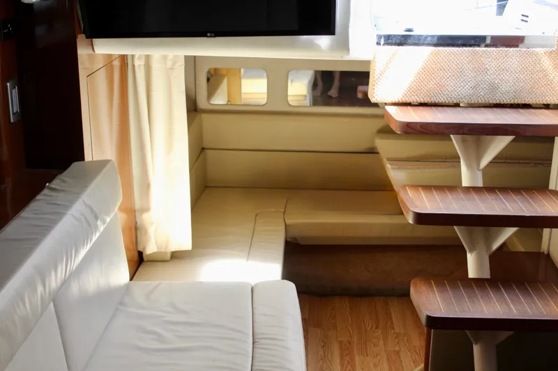 Slide: The Image of Interior of 2011 Sea Ray Sundancer 350 yacht with cozy seating and wooden steps. - 28