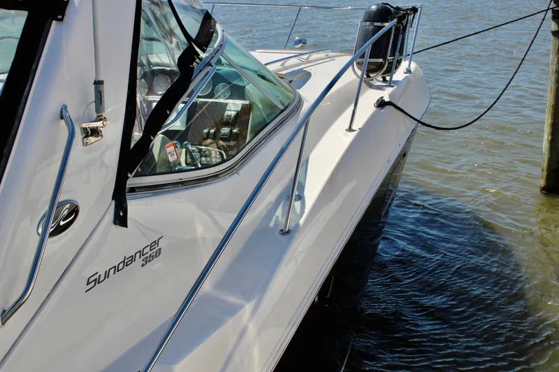 Slide: The Image of 2011 Sea Ray Sundancer 350 yacht docked on calm water. - 3