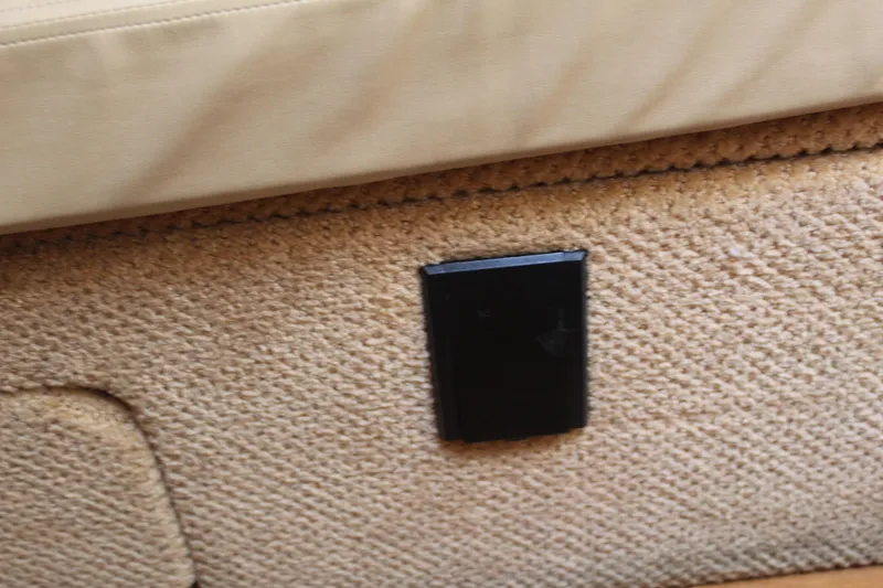 Slide: The Image of Interior detail of a 2011 Sea Ray Sundancer 350, featuring beige upholstery and a black panel. - 30