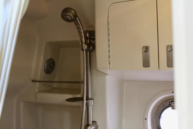 Slide: The Image of Shower area in 2011 Sea Ray Sundancer 350 yacht with porthole and storage cabinets. - 32