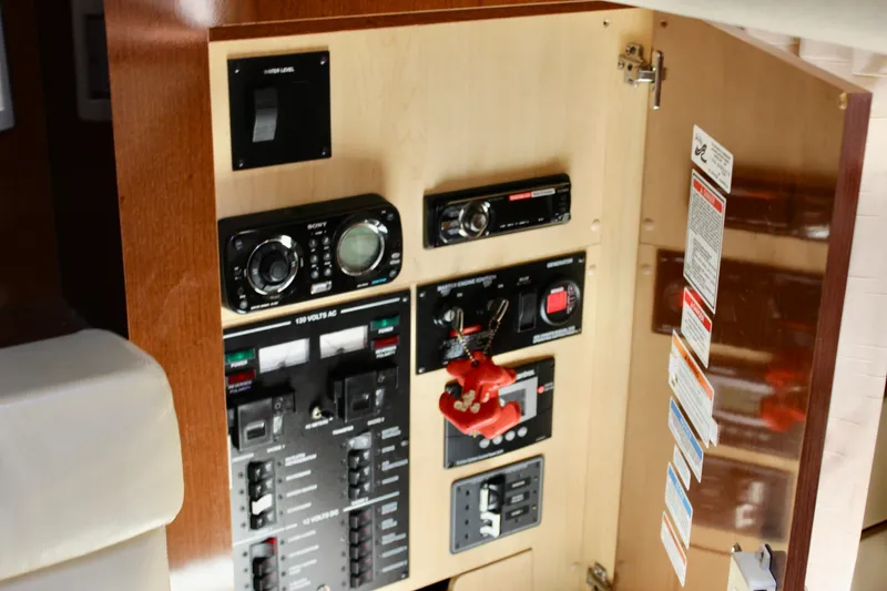 Slide: The Image of Control panel inside 2011 Sea Ray Sundancer 350 boat, featuring switches and gauges. - 33