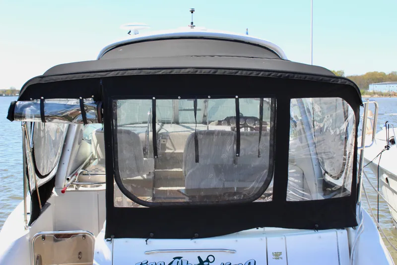 Slide: The Image of 2011 Sea Ray Sundancer 350 yacht with black canvas enclosure at dock. - 6