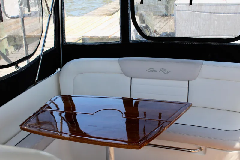 Slide: The Image of Interior of 2011 Sea Ray Sundancer 350 with polished wooden table and white seating. - 7