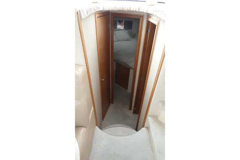 Slide: The Image of Interior view of 2003 Meridian 341 Sedan yacht cabin with wooden doors and cozy bedding. - 10