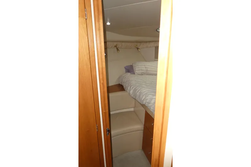 Slide: The Image of Interior cabin of 2003 Meridian 341 Sedan yacht with bed and wooden cabinetry. - 11