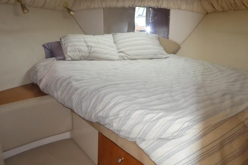Slide: The Image of Cozy bedroom interior of 2003 Meridian 341 Sedan yacht with striped bedding. - 12