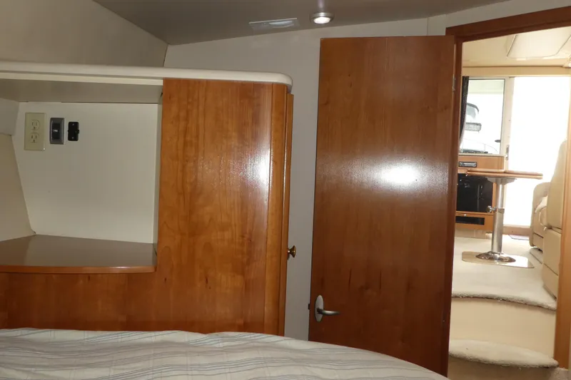 Slide: The Image of Interior cabin view of a 2003 Meridian 341 Sedan yacht, featuring wood finishes and cozy furnishings. - 14