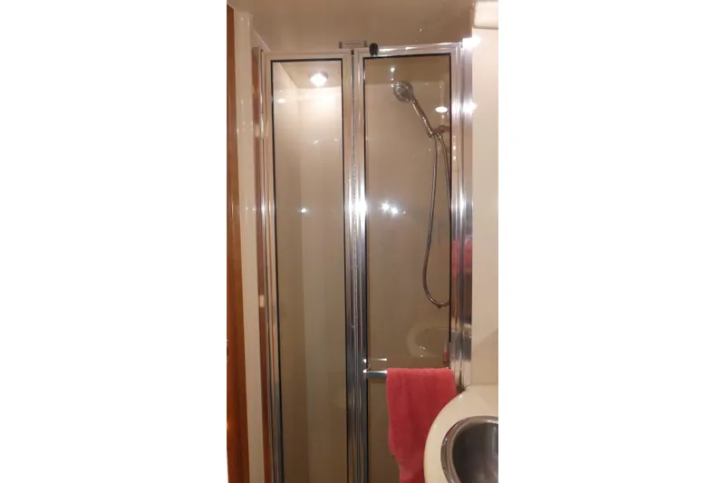 Slide: The Image of Shower area in 2003 Meridian 341 Sedan yacht with glass door and chrome fixtures. - 16