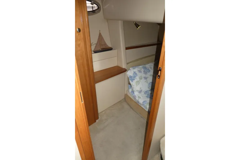 Slide: The Image of Interior cabin of 2003 Meridian 341 Sedan with floral bedding and wooden accents. - 17
