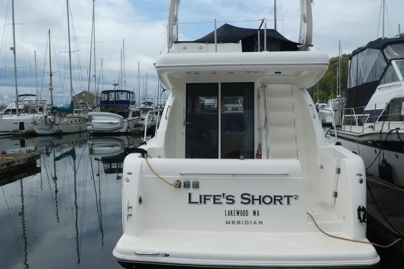 Slide: The Image of 2003 Meridian 341 Sedan yacht docked at marina, named "Life's Short," Lakewood, WA. - 2