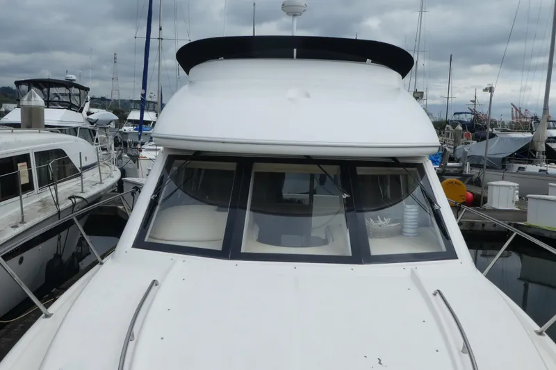 Slide: The Image of 2003 Meridian 341 Sedan yacht docked at a marina under cloudy skies. - 23