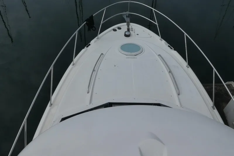 Slide: The Image of Top view of a 2003 Meridian 341 Sedan yacht's bow, featuring sleek design and railing. - 24