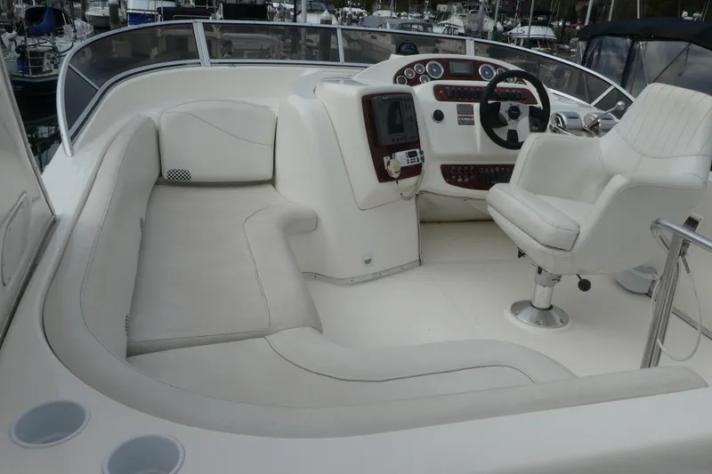 Slide: The Image of 2003 Meridian 341 Sedan boat cockpit with white seating and control panel. - 25