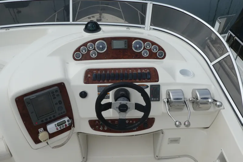 Slide: The Image of 2003 Meridian 341 Sedan helm with steering wheel, controls, and navigation instruments. - 27